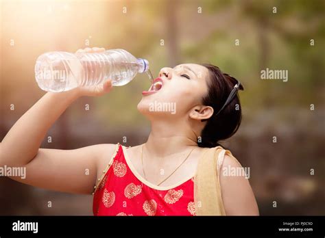 Beautiful Indian Woman Drinking Water From Bottle Stock Photo Alamy