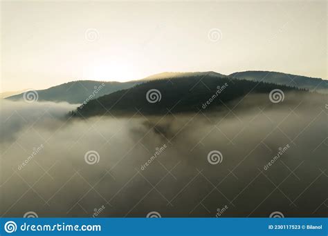 Aerial View Of Vibrant Sunset Over White Dense Foggy Clouds With