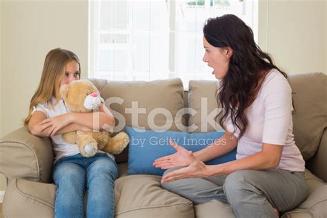 Angry Mother Shouting At Daughter On Sofa Stock Photos