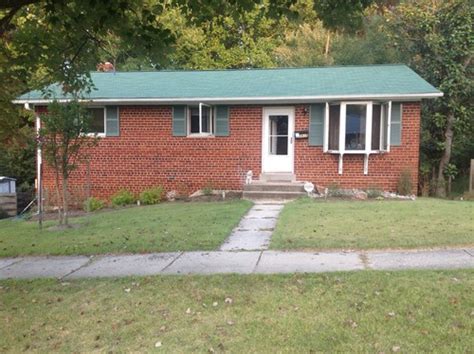 Here, the red brick does not exist on the wall of the house. Green roof on a brick ranch -- gutter and trim advice, please!