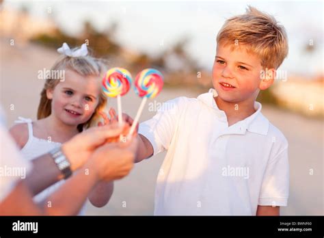 Cute Brother And Sister Picking Out Lollipop From Their Mom At The