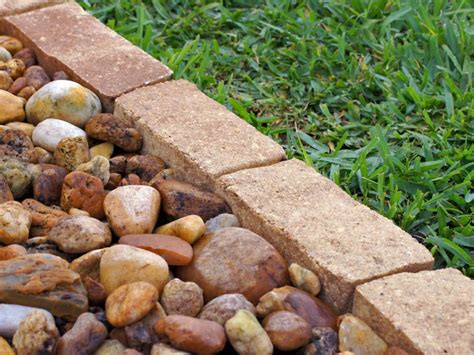 Attach 2x forms to the stakes below ground level and spread the gravel base. How to Install Garden Edging | HGTV