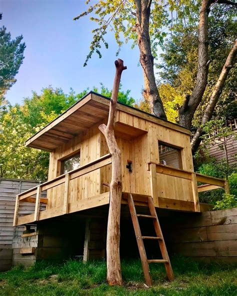 Dad Builds Garden Treehouse with Slides For His Daughters