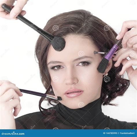 Beautiful Young Woman Holding Make Up Brushes Isolated On A White