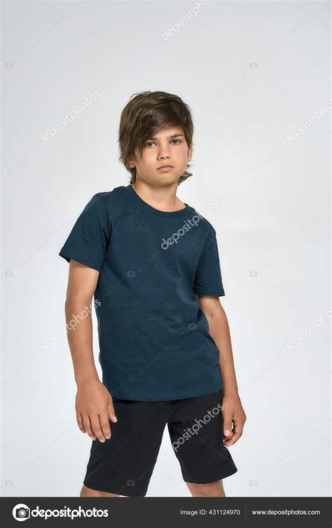 Little Sportive Boy Child In Sportswear Looking At Camera While
