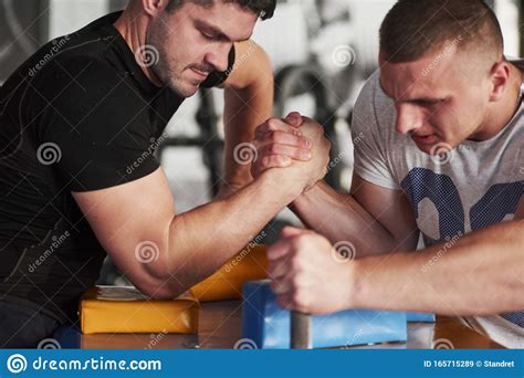 Fully Concentrated On The Game Arm Wrestling Challenge Between Two Men