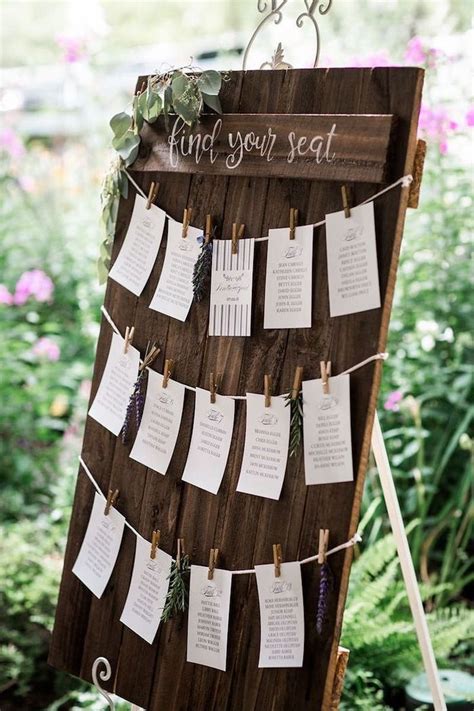 Wooden Seating Chart Papers Pinned With Pins Greenery In The