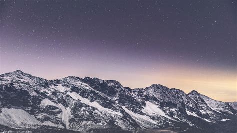 Download Wallpaper 1366x768 Snow Covered Mountains Stars Nature
