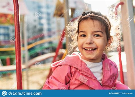 Outdoor Closeup Portrait Of Happy Little Girl Smiling Broadly Wearing