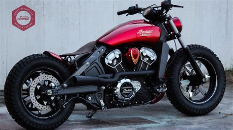 A Red And Black Motorcycle Parked In Front Of A White Building With
