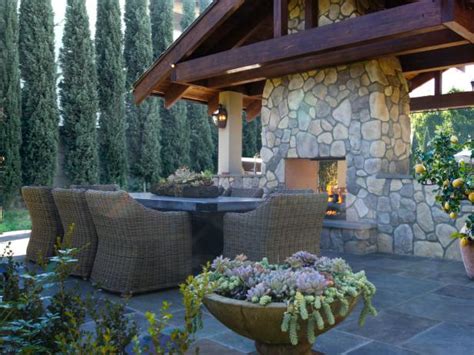 Outdoor Dining Area With Stone Fireplace And Wicker