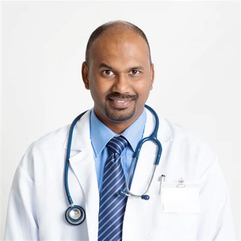 Confident Mature Indian Doctor Stock Photo By ©szefei 87652026