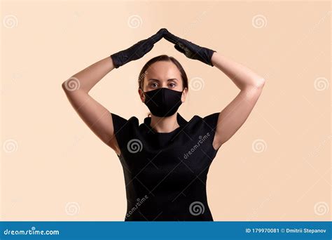 Woman In Black Dress Face Mask And Latex Gloves Holding Two Hands Above