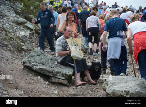 A Barefoot Pilgrim Taking A Rest While Climbing Croagh Patrick Co