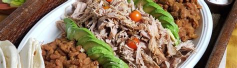 Place pork in a shallow roasting pan coated with cooking spray. Tomatillo Shredded Pork Roast and Pinto Beans for Slow Cooker | thefitfork.com