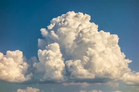 A Big And Fluffy Cumulonimbus Cloud In The Blue Sky Clouds