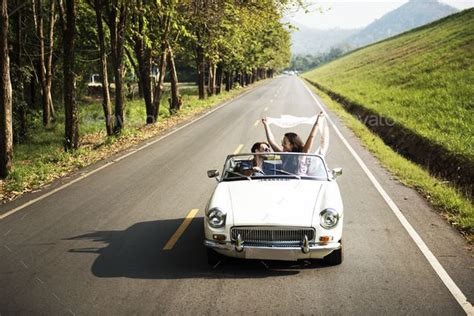 Couple Driving A Car Traveling On Road Trip Together Road Trip