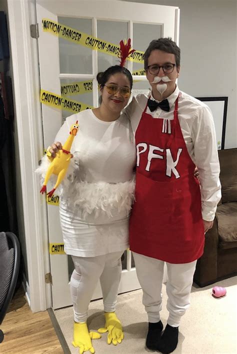 A Man And Woman Dressed Up In Costumes For The Costume Contest Standing Next To Each Other