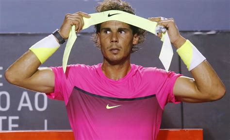 Rafael Nadal Of Spain Puts On His Headband During A Break Of His Mens