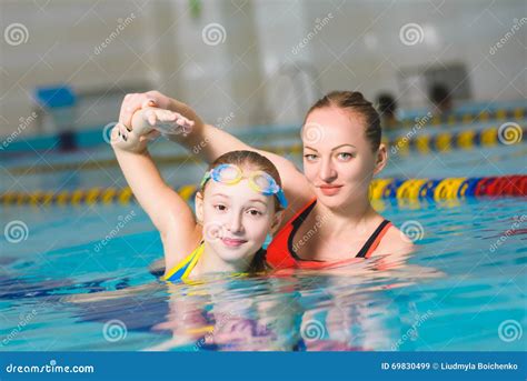 Instructor Teaches The Girl Swimming In A Pool Stock Image Image Of