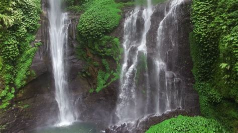 Tilt Up Of Beautiful Waterfall In Green Tropical Forest