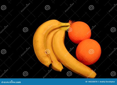 Bananas And Oranges Lie On A Black Tropical Fruit Stock Photo Image
