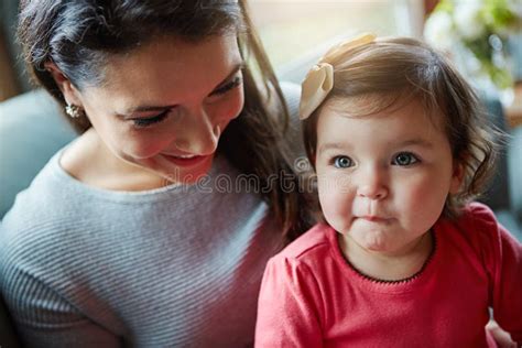 cute is my natural state a mother bonding with her adorable little daughter at home stock