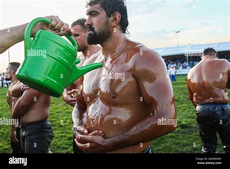 An Oil Wrestler Gets Oil On His Body Before The Start Of The Competitions During The Traditional