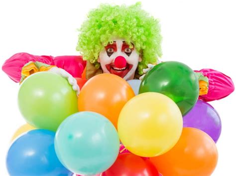 Portrait Of Two Children Dressed As Colorful Funny Clowns Stock Photo