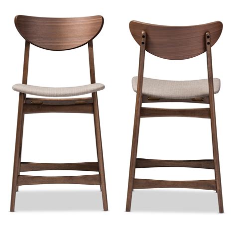 The metal base features four slim legs with crossbars that provide extra support. Latano Danish Modern Counter Stools (Set of 2) | Mid Decco