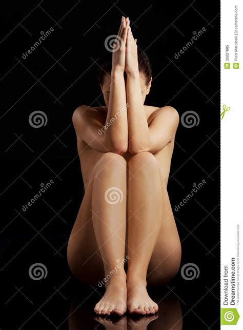 Beautiful Naked Woman Sitting With Hand And Legs Together