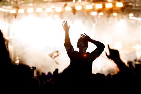 Rock Concert Silhouettes Of Happy People Raising Up Hands Stock Photo
