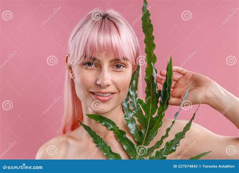 Portrait Of Beautiful Naked Woman With Pink Hair Smiling At Camera Posing With Plant Leaf