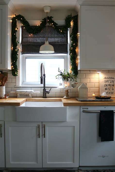 I added the garland above the middle cabinet first and then added the three red sunflower stems on the side. 5 Ways to Create a Cozy Kitchen at Christmas - Nesting ...