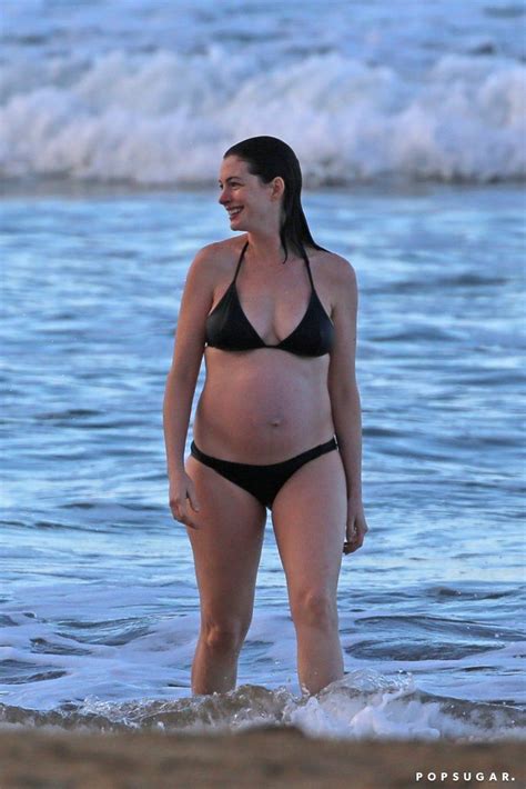 Anne Hathaway Shows Off Her Baby Bump During A Sunset Swim Anne Hathaway Pregnant Anne