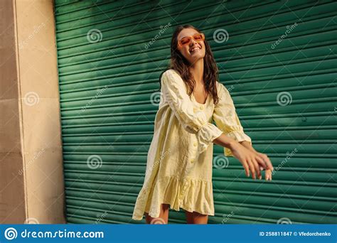 Positive Young Caucasian Brunette Girl Enjoys Walk Around City On