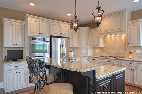 If you need a little assistance embracing your dark side, you kandra kole interiors gave this traditional kitchen a retro lift thanks to red appliances and black cabinetry. Cream Colored Kitchen Cabinets With Black Stainless Steel ...