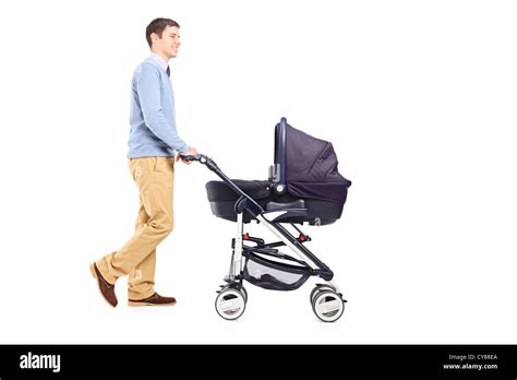 Full Length Portrait Of A Father Pushing A Baby Stroller Isolated On