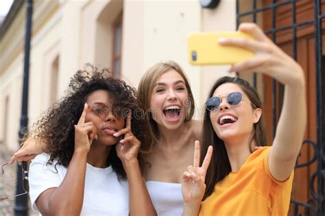Three Cute Young Girls Friends Having Fun Together Taking A Selfie At The City Stock Image