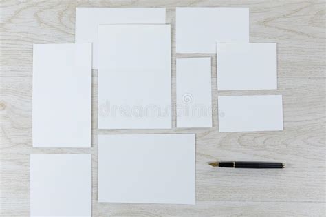 White Sheet Of Papers And A Pen On Wood Table Stock Photo Image Of