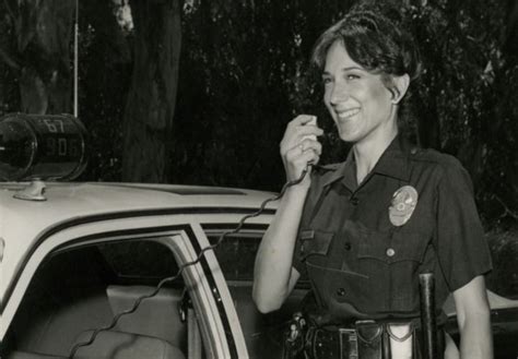 A Female Police Officer Working Patrol In The 1980s Uses Her Two Way