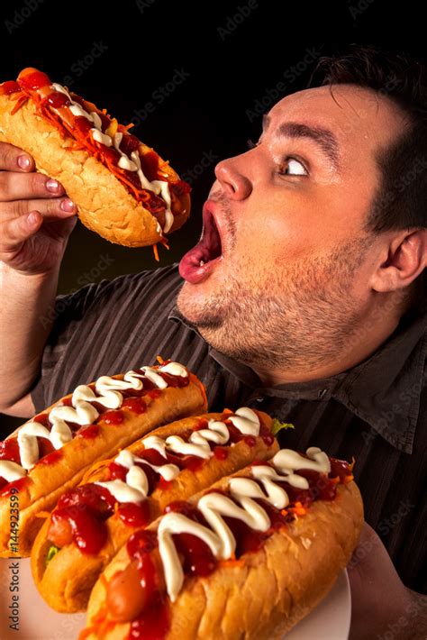 Diet Failure Of Fat Man Eating Fast Food Hot Dog On Plate Close Up Of