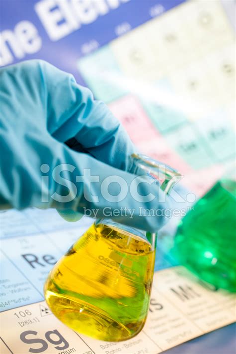 Science Scientist Holds Lab Beaker With Periodic Table Backgrou Stock