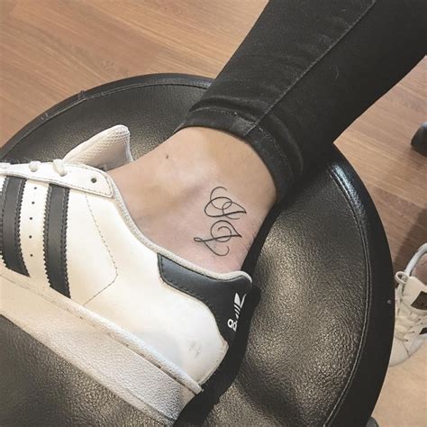 This detailed tattoo looks like it's one of the dotted designs. 60 Charming Initial Tattoo Designs - Keep a Loved One Closer