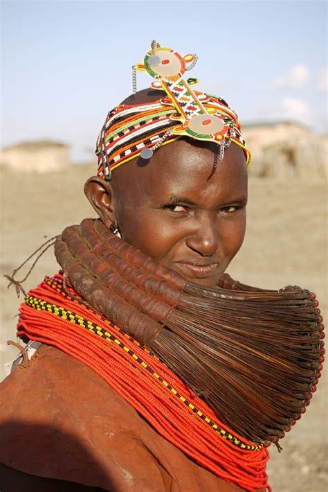 A Woman Wearing A Colorful Head Piece In The Desert