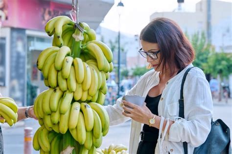 Premium Photo Woman Buying Bananas At A Street Retail Market