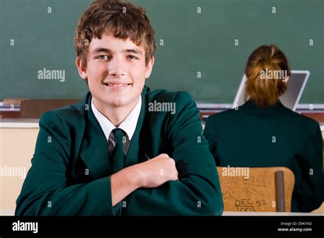 High School Boy In Classroom With Classmate Stock Photo Alamy