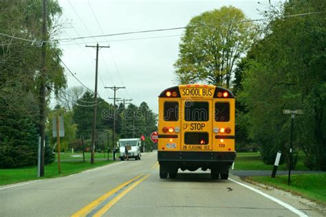 Rural School Bus Stopped To On Wisconsin Road With Flashing Lights