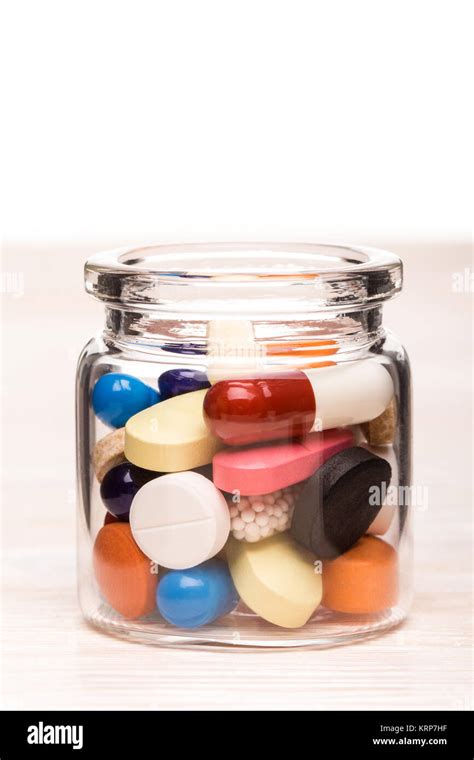 Colored Pills In Transparent Glass Container Stock Photo Alamy