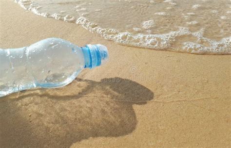 Plastic Water Bottles Pollution In Ocean On The Shore Stock Photo